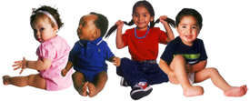 Photo of four children smiling.