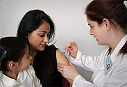 Photograph of adult female being vaccinated.