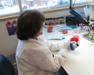 A microbiologist is inoculating and streaking a Group A Strep isolate to a blood agar plate. The isolate will be frozen in cryovials to be forwarded to the CDC.